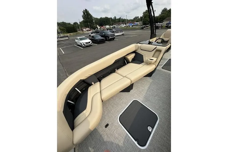 Slide: The Image of Luxurious seating on 2026 Flamingo Rove 24' boat, parked in a lot with cars. - 17