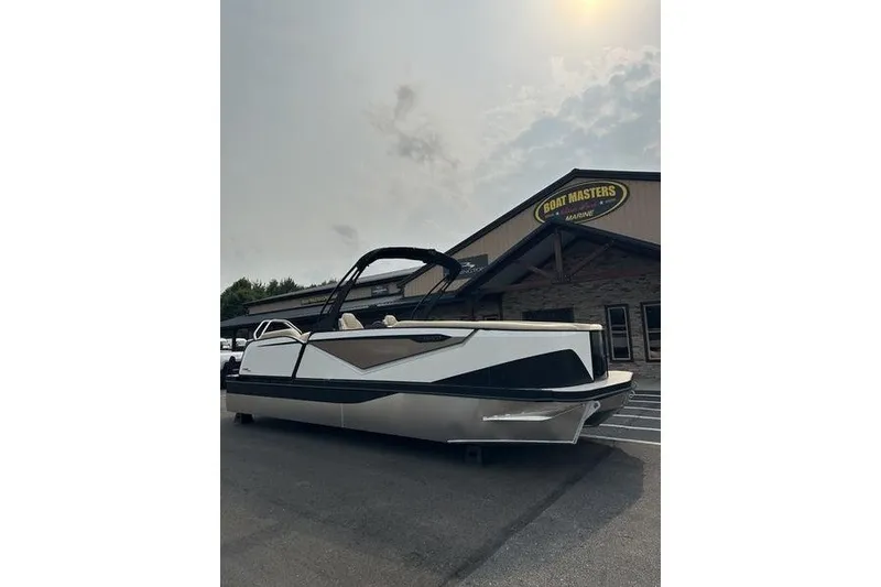 Slide: The Image of 2026 Flamingo Rove 24' boat parked outside dealership under cloudy sky. - 3