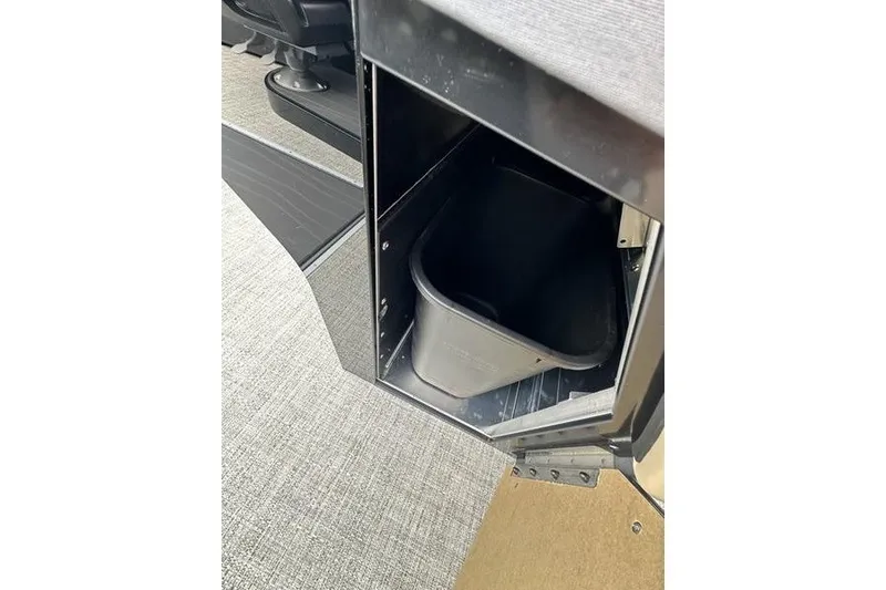 Slide: The Image of Storage compartment with a black bin inside a 2026 Flamingo Rove 24' vehicle. - 34