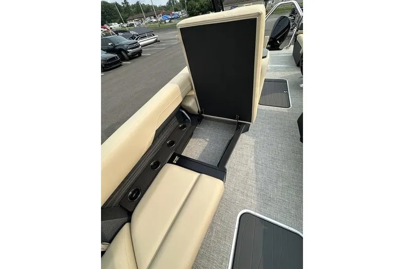 Slide: The Image of 2026 Flamingo Rove 24' boat interior with beige seating and cup holders. - 24