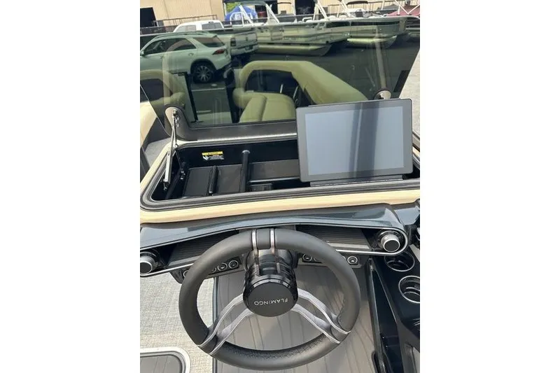 Slide: The Image of Steering wheel and dashboard of 2026 Flamingo Rove 24' boat with touchscreen display. - 36