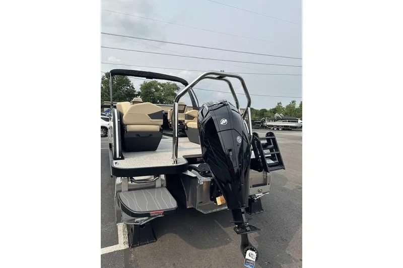 Slide: The Image of 2026 Flamingo Rove 24' boat with sleek black motor, parked outdoors. - 5