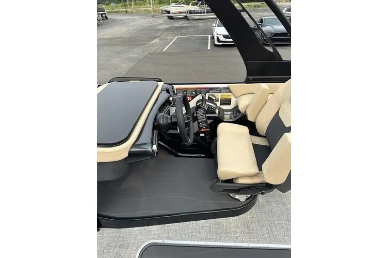 Slide: The Image of Interior of 2026 Flamingo Rove 24' boat with beige seating and modern dashboard. - 37