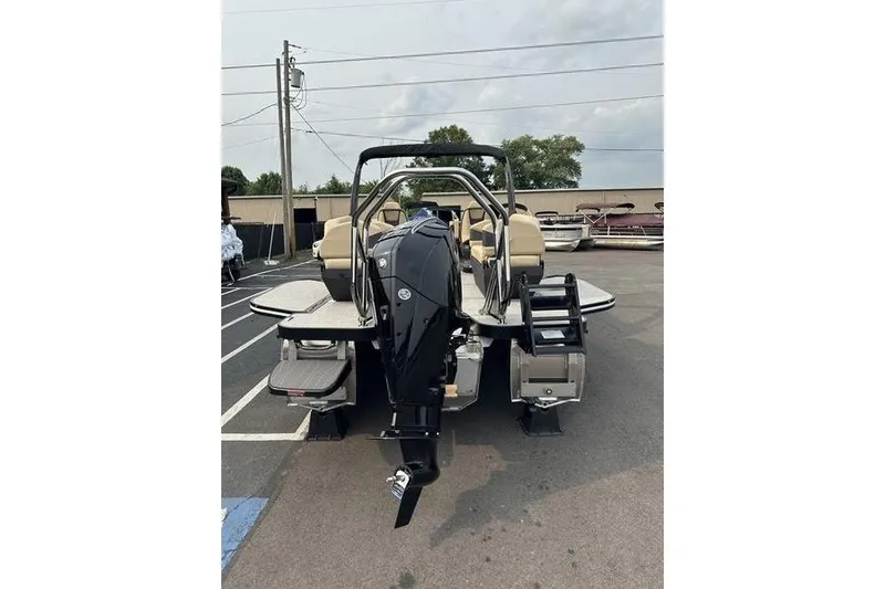 Slide: The Image of 2026 Flamingo Rove 24' boat with powerful outboard motor in a parking lot. - 13
