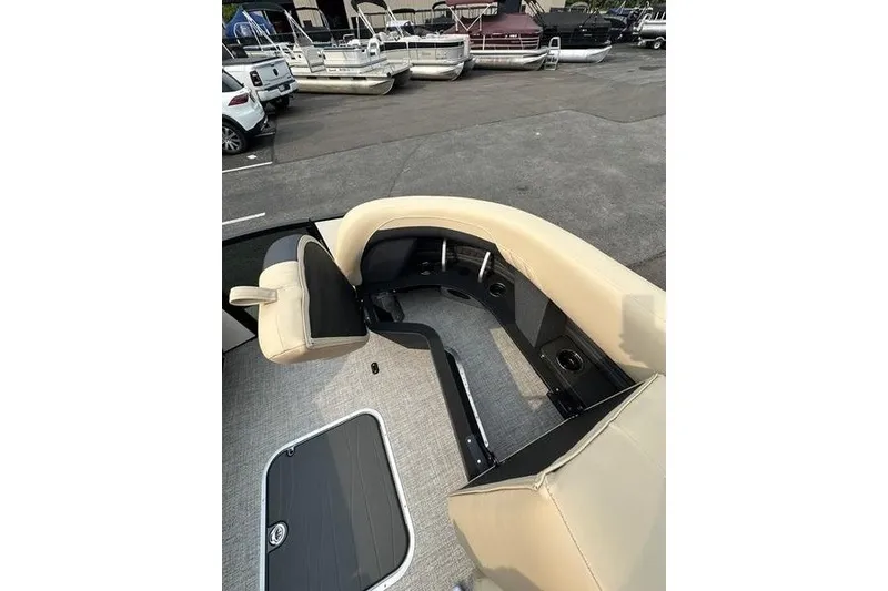 Slide: The Image of 2026 Flamingo Rove 24' boat interior with beige seating and storage compartment. - 23