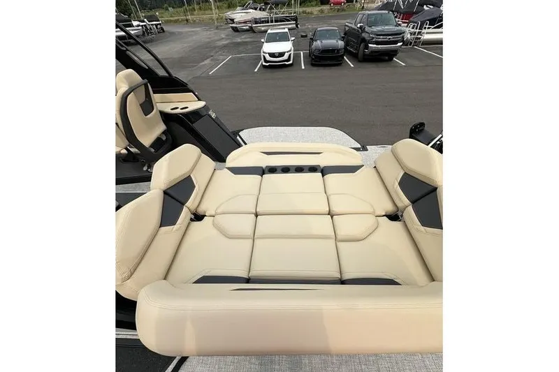 Slide: The Image of Luxurious seating on 2026 Flamingo Rove 24' boat, featuring beige upholstery in a parking lot setting. - 4