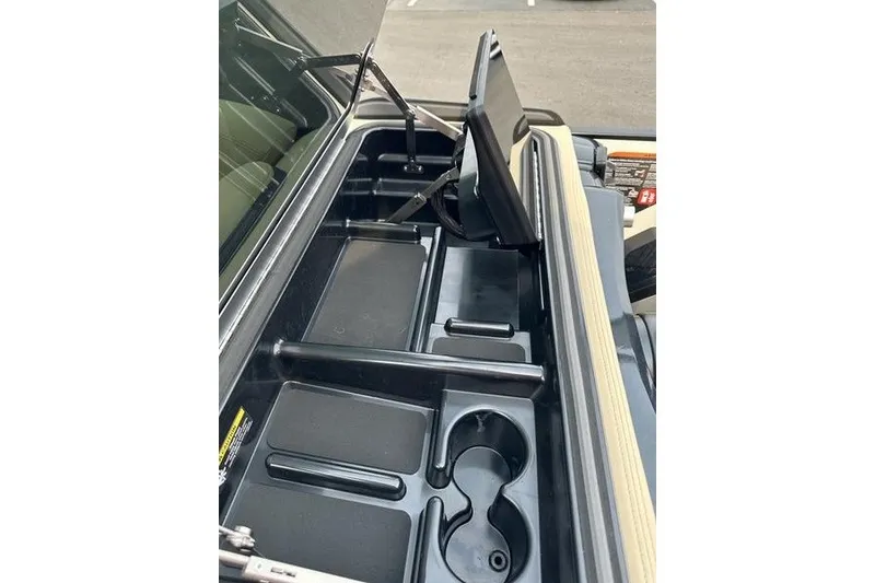 Slide: The Image of Interior storage compartments of 2026 Flamingo Rove 24' with cup holders and tray. - 32