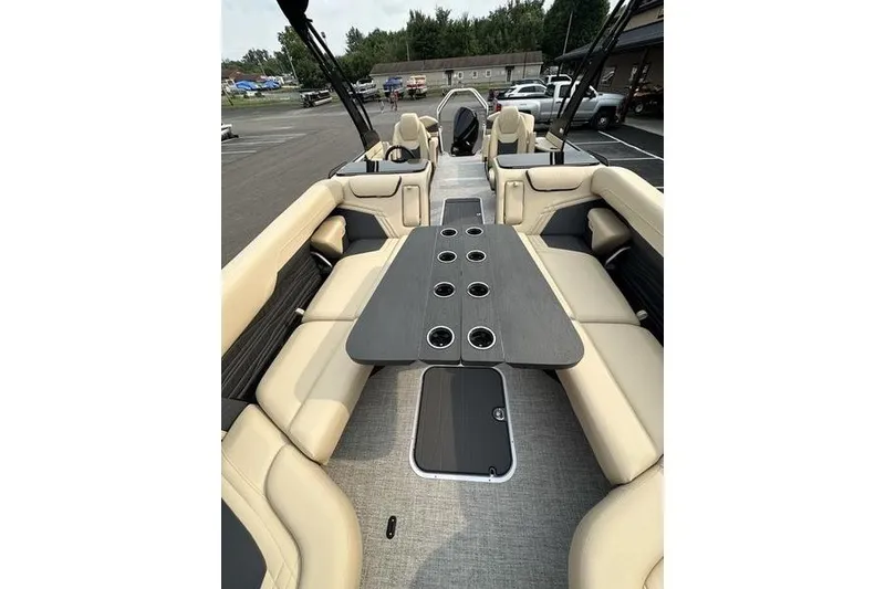 Slide: The Image of Luxurious interior of 2026 Flamingo Rove 24' boat with beige seating and sleek table design. - 15