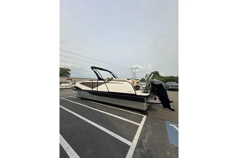 Slide: The Image of 2026 Flamingo Rove 24' boat parked in a lot, showcasing sleek design and modern features. - 6