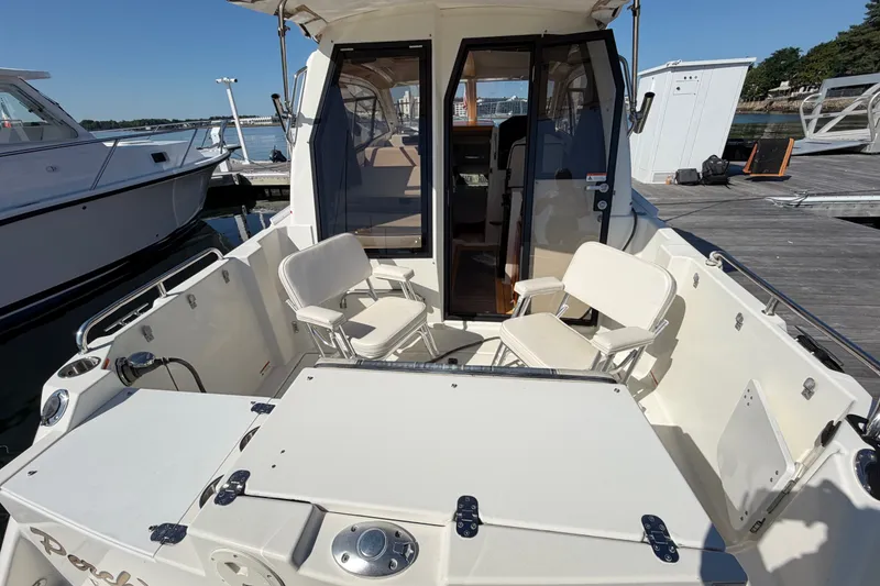 Slide: The Image of 2017 Cutwater C-242 Coupe boat interior with seating, docked at marina. - 6