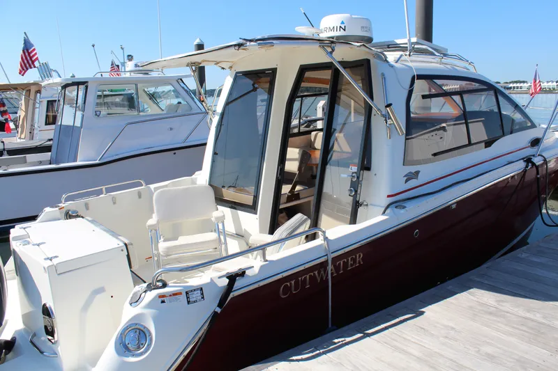 Slide: The Image of 2017 Cutwater C-242 Coupe boat docked at marina, rear view. - 4