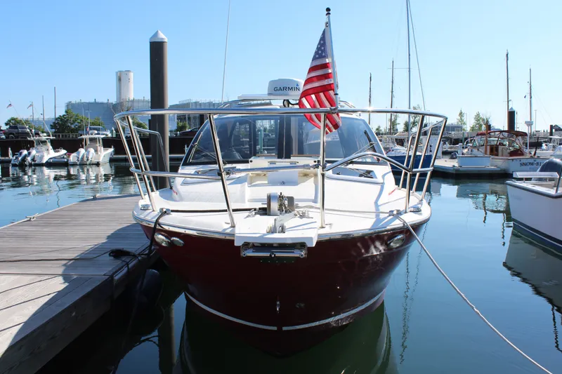 Slide: The Image of 2017 Cutwater C-242 Coupe docked at marina, featuring sleek design and American flag. - 3