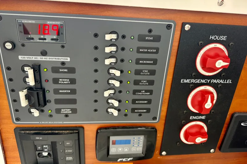 Slide: The Image of Electrical control panel of a 2017 Cutwater C-242 Coupe boat, featuring switches and gauges. - 20