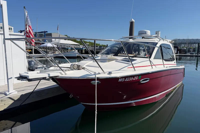 The Image of 2017 Cutwater C-242 Coupe boat docked at marina, featuring sleek red and white design. - 0