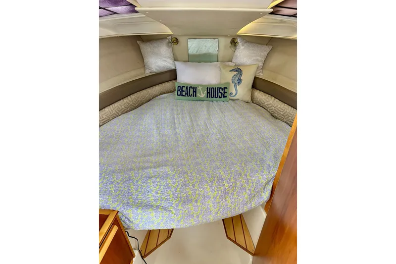 Slide: The Image of Cozy cabin interior of 2017 Cutwater C-242 Coupe with decorative pillows and bedding. - 21