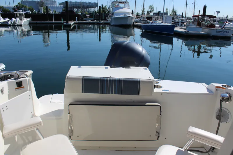 Slide: The Image of 2017 Cutwater C-242 Coupe boat docked at a marina with calm water. - 7