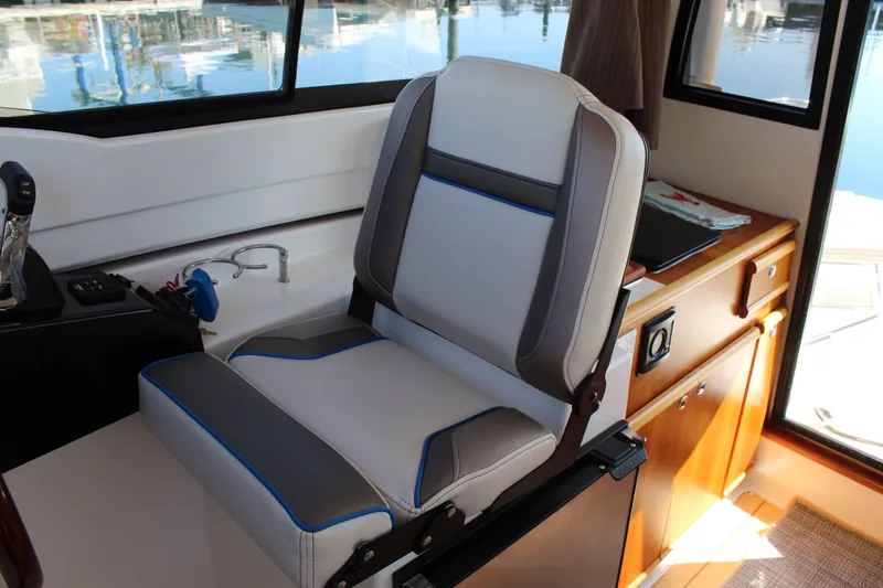 Slide: The Image of 2017 Cutwater C-242 Coupe interior with a modern captain's chair and control panel. - 13