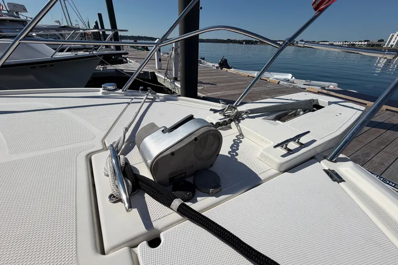 Slide: The Image of 2017 Cutwater C-242 Coupe boat deck with anchor and winch at marina. - 24