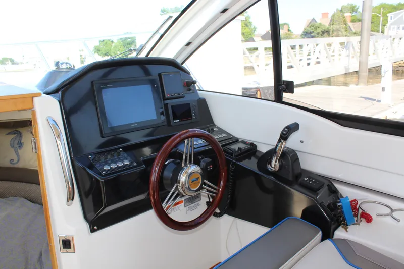 Slide: The Image of Interior helm of 2017 Cutwater C-242 Coupe with steering wheel and navigation controls. - 15