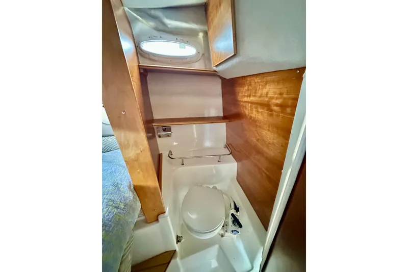Slide: The Image of 2017 Cutwater C-242 Coupe bathroom with wooden cabinetry and compact toilet. - 23