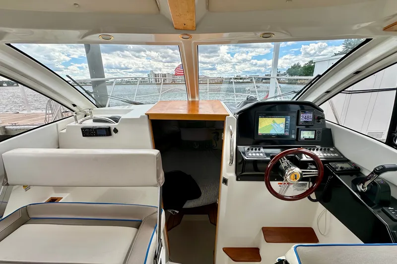 Slide: The Image of Interior view of a 2017 Cutwater C-242 Coupe boat with navigation equipment and seating. - 16