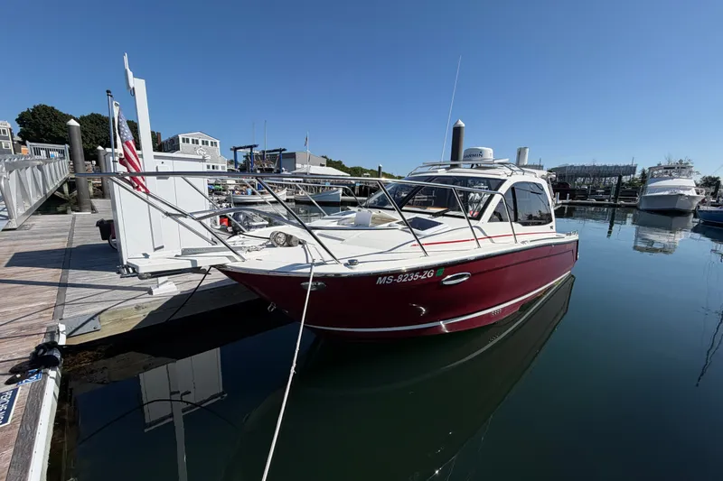 Slide: The Image of 2017 Cutwater C-242 Coupe docked at a marina under clear blue skies. - 2