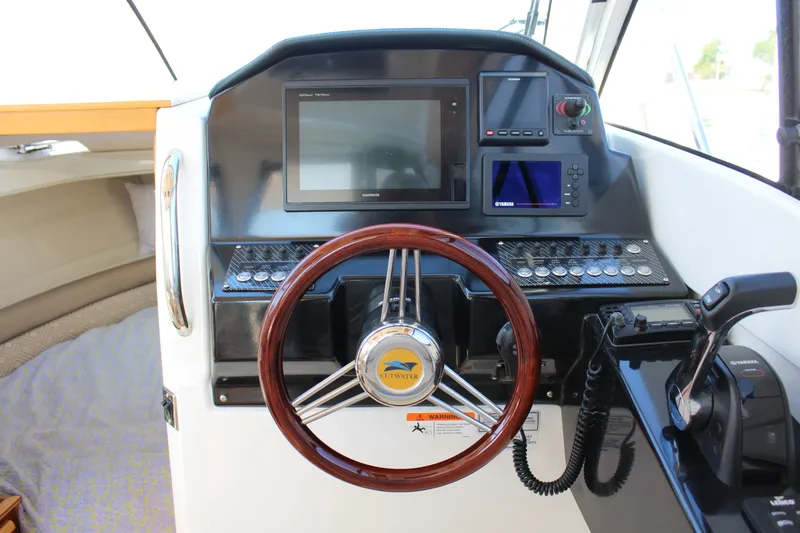 Slide: The Image of Helm of 2017 Cutwater C-242 Coupe with steering wheel and navigation controls. - 14