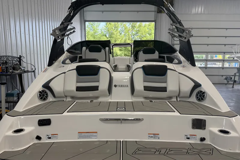 Slide: The Image of 2022 Yamaha Boats 212XD in a garage, showcasing sleek seating and modern design. - 2