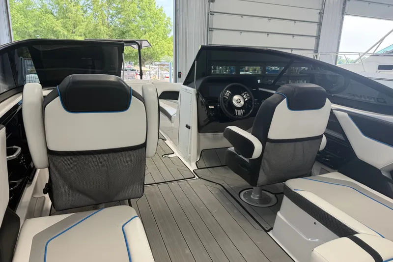 Slide: The Image of 2022 Yamaha Boats 212XD interior with modern seating and sleek dashboard design. - 4