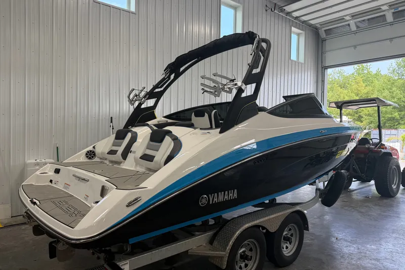 Slide: The Image of 2022 Yamaha Boats 212XD in a garage, showcasing sleek design and modern features. - 1