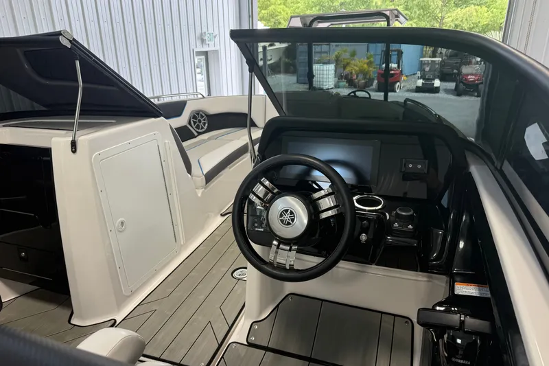 Slide: The Image of Interior view of 2022 Yamaha Boats 212XD, featuring sleek steering and modern dashboard. - 8