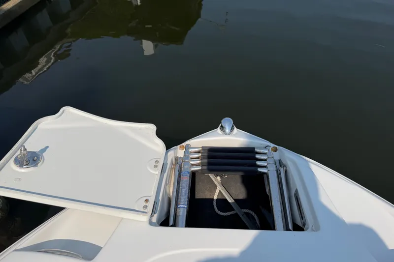 Slide: The Image of Bow of a 2008 Crownline 240 LS boat with open anchor compartment. - 6