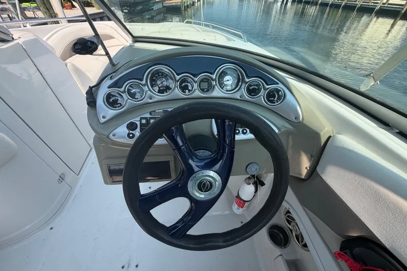 Slide: The Image of Steering wheel and dashboard of a 2008 Crownline 240 LS boat, dockside view. - 18