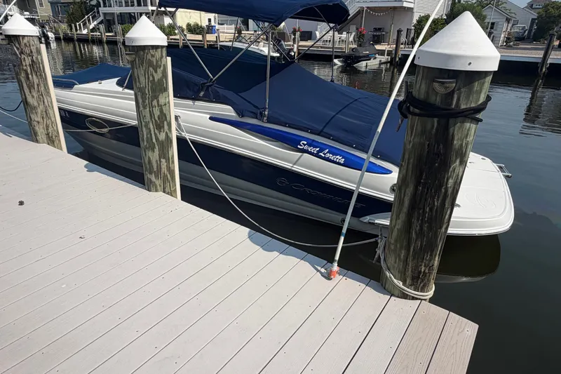 Slide: The Image of 2008 Crownline 240 LS boat docked with blue cover and canopy. - 5