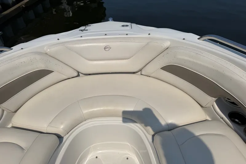 Slide: The Image of 2008 Crownline 240 LS boat interior with white cushioned seating. - 7