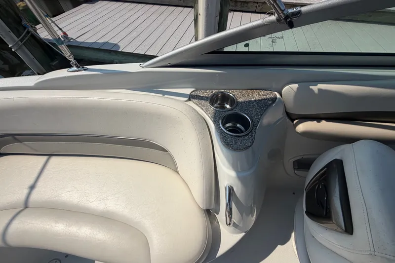 Slide: The Image of Interior of 2008 Crownline 240 LS boat with cup holders and white seating. - 24