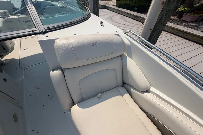 Slide: The Image of 2008 Crownline 240 LS boat interior with white leather seating near dock. - 11