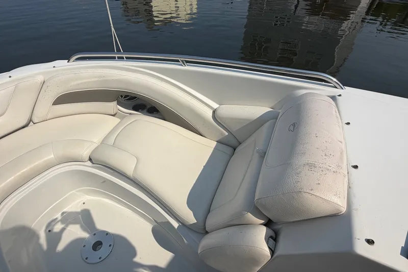 Slide: The Image of 2008 Crownline 240 LS boat interior with white leather seating by the water. - 12