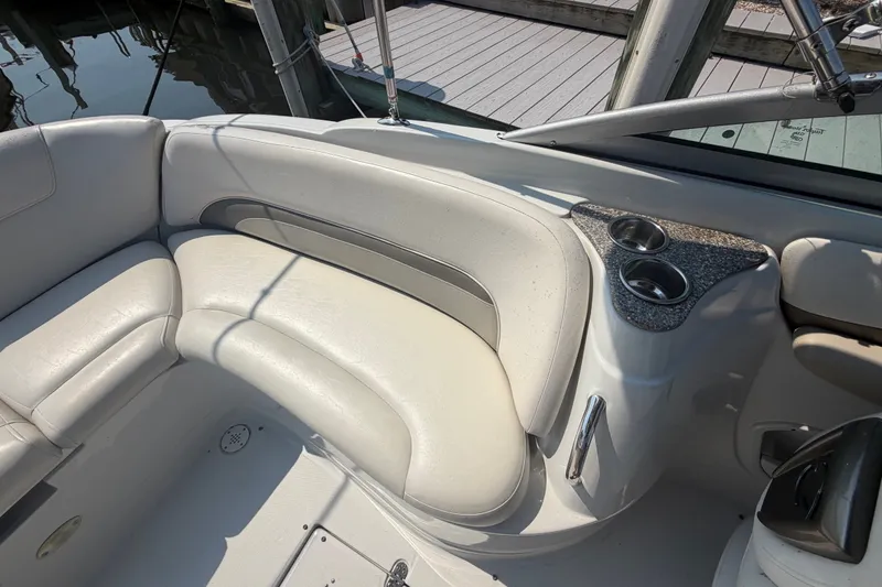 Slide: The Image of 2008 Crownline 240 LS boat interior with white seating and cup holders. - 28