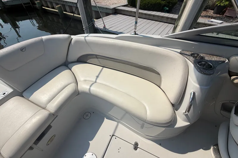 Slide: The Image of 2008 Crownline 240 LS boat interior with white seating and cup holders. - 27