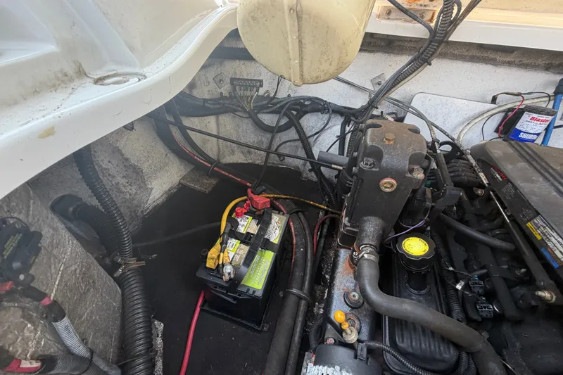 Slide: The Image of Engine compartment of a 2008 Crownline 240 LS boat, featuring battery and wiring. - 34