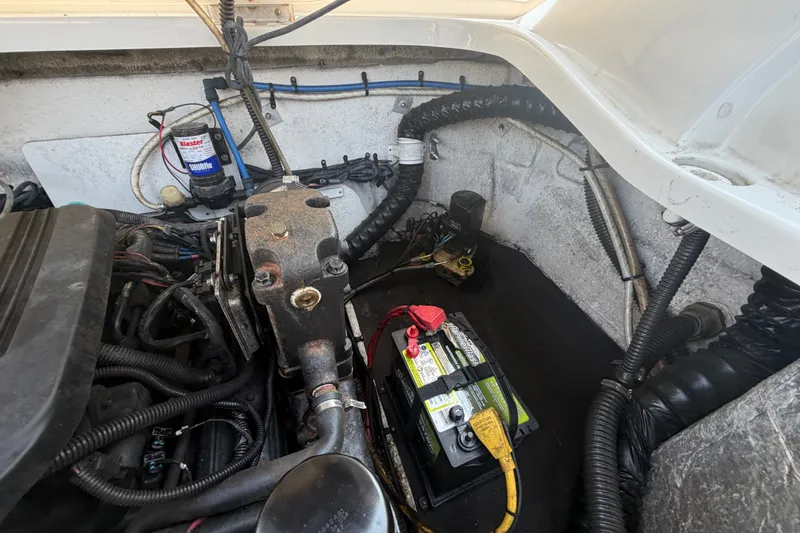 Slide: The Image of Engine compartment of a 2008 Crownline 240 LS boat, featuring battery and wiring. - 33