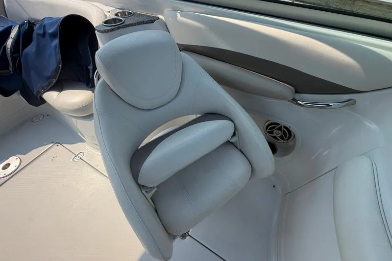 Slide: The Image of 2008 Crownline 240 LS boat interior with white seating and cup holders. - 20