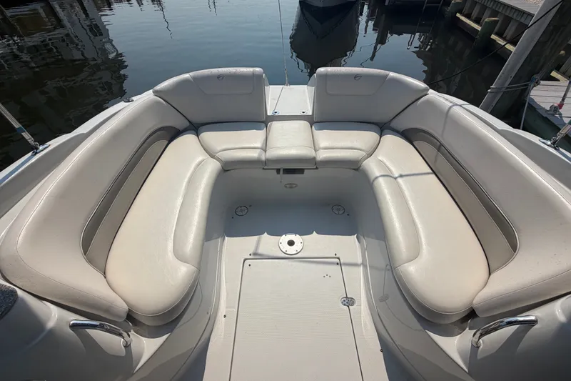 Slide: The Image of Spacious seating area on a 2008 Crownline 240 LS boat, docked by the water. - 23
