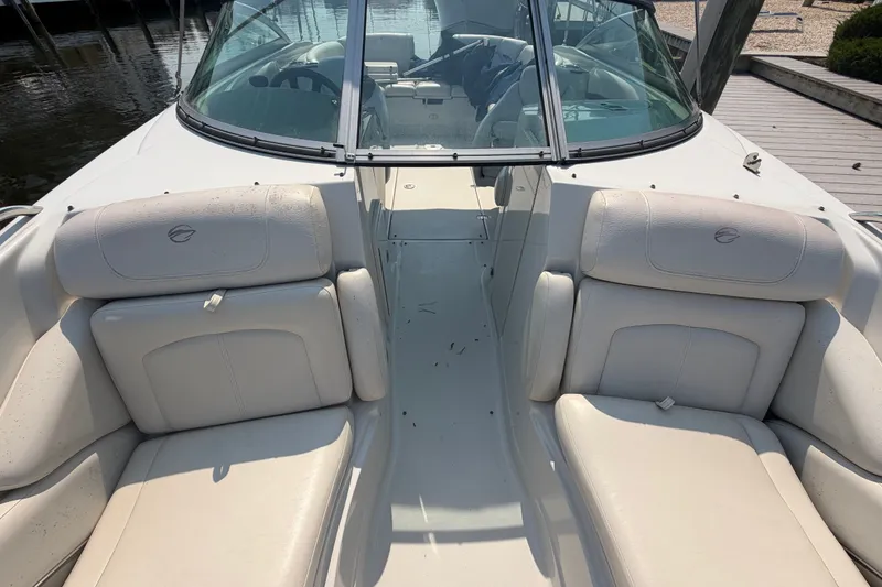 Slide: The Image of 2008 Crownline 240 LS boat interior with white leather seating and windshield. - 14