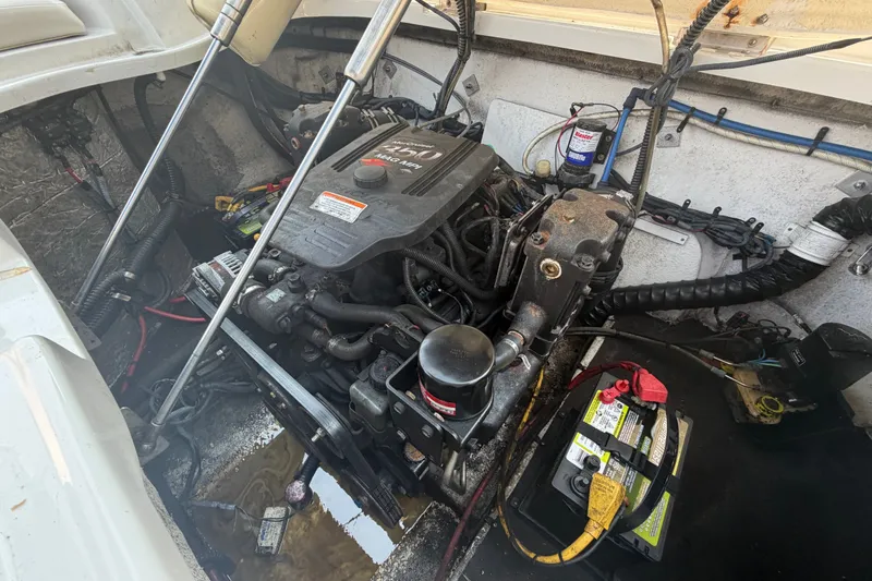 Slide: The Image of Engine compartment of a 2008 Crownline 240 LS boat, showing motor and battery. - 35