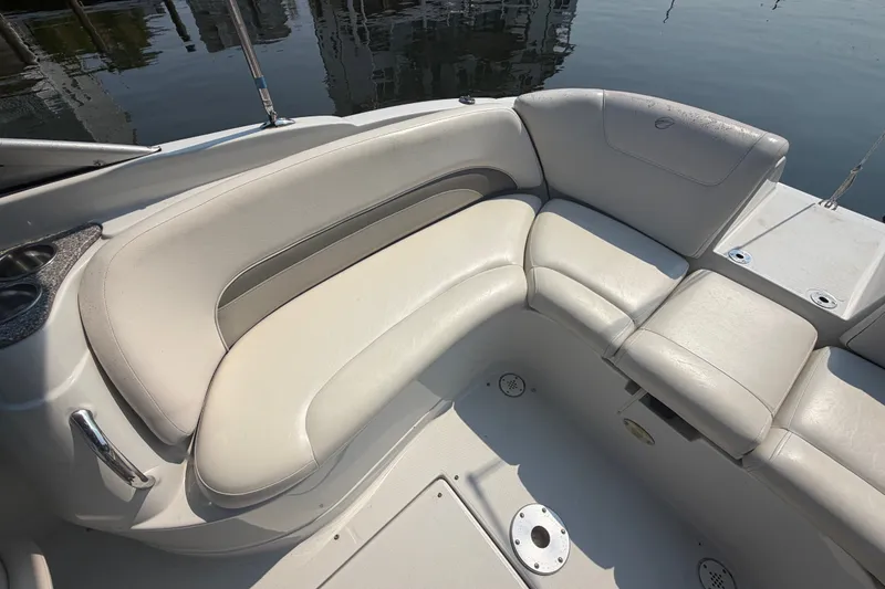 Slide: The Image of 2008 Crownline 240 LS boat interior with white leather seating and cup holders. - 25