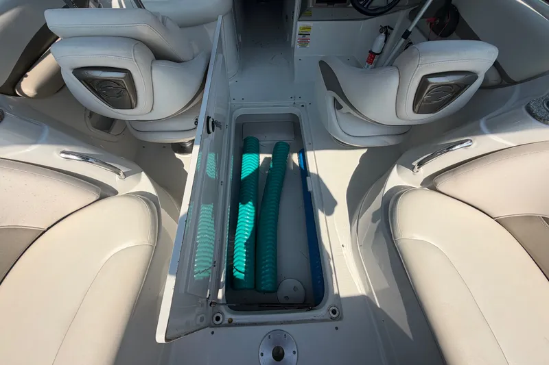 Slide: The Image of 2008 Crownline 240 LS boat interior with open storage compartment and seating. - 22