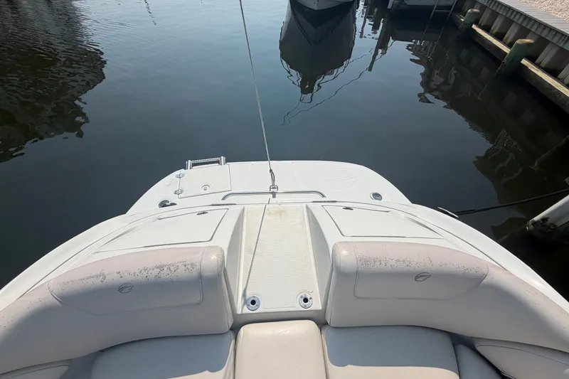 Slide: The Image of 2008 Crownline 240 LS boat stern view at dock, featuring swim platform and seating. - 15