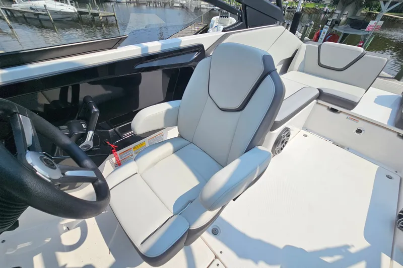 Slide: The Image of 2023 Yamaha Boats AR250 interior with sleek captain's chair and steering wheel. - 21